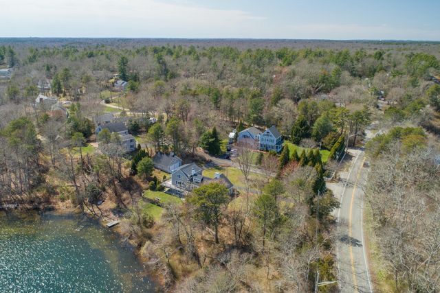 a view of a lake with a mountain and a floor to ceiling window