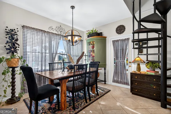 a bedroom with a bed and a flat tv screen on the dresser