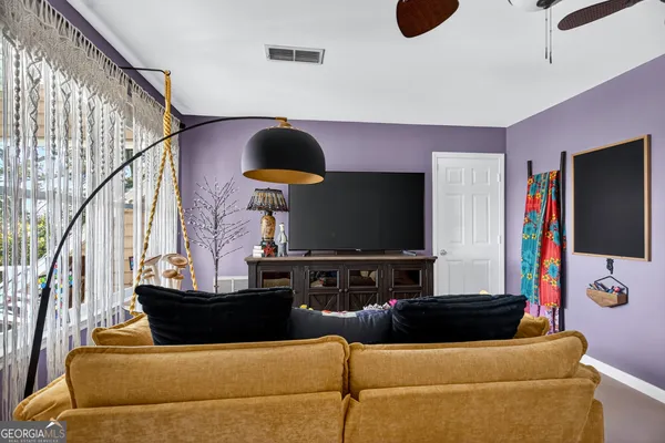 a living room with furniture and a flat screen tv