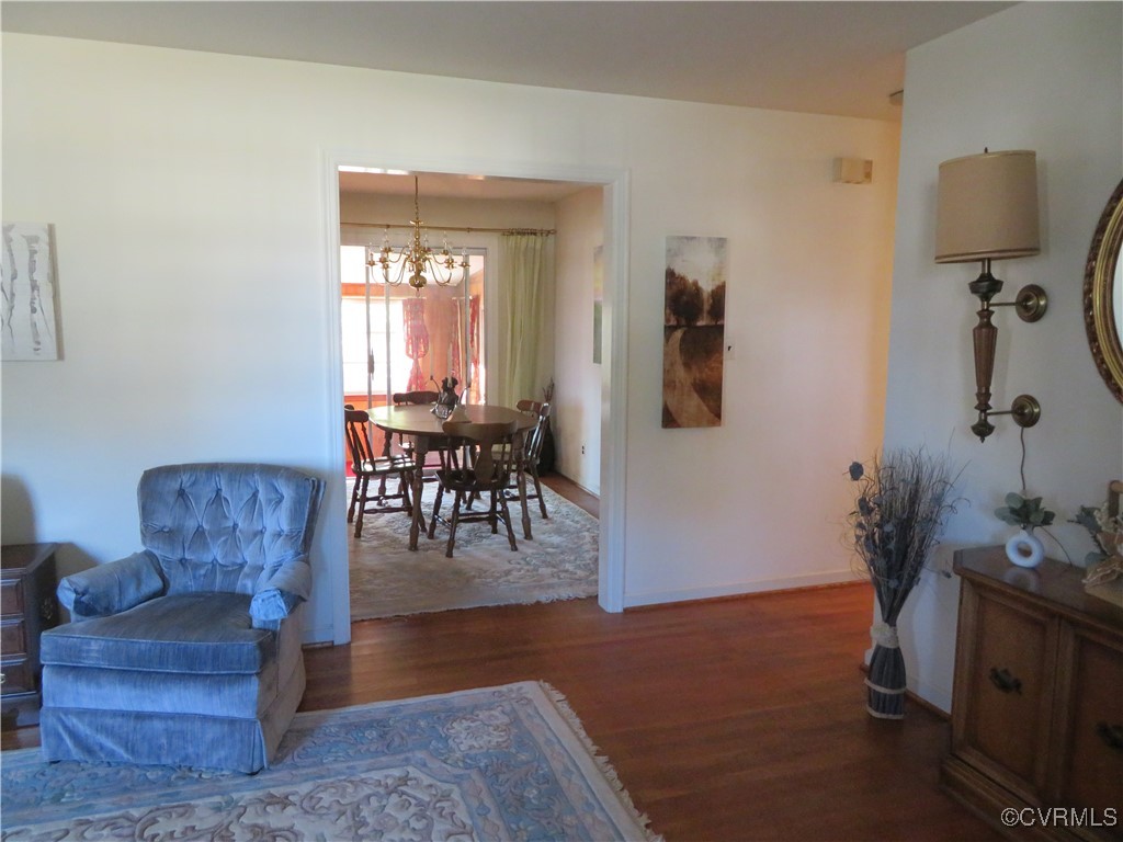 4612 Fairway Road Petersburg, VA 23803 - Photo 22 of 50 a living room with furniture a dining table and paintings on the wall