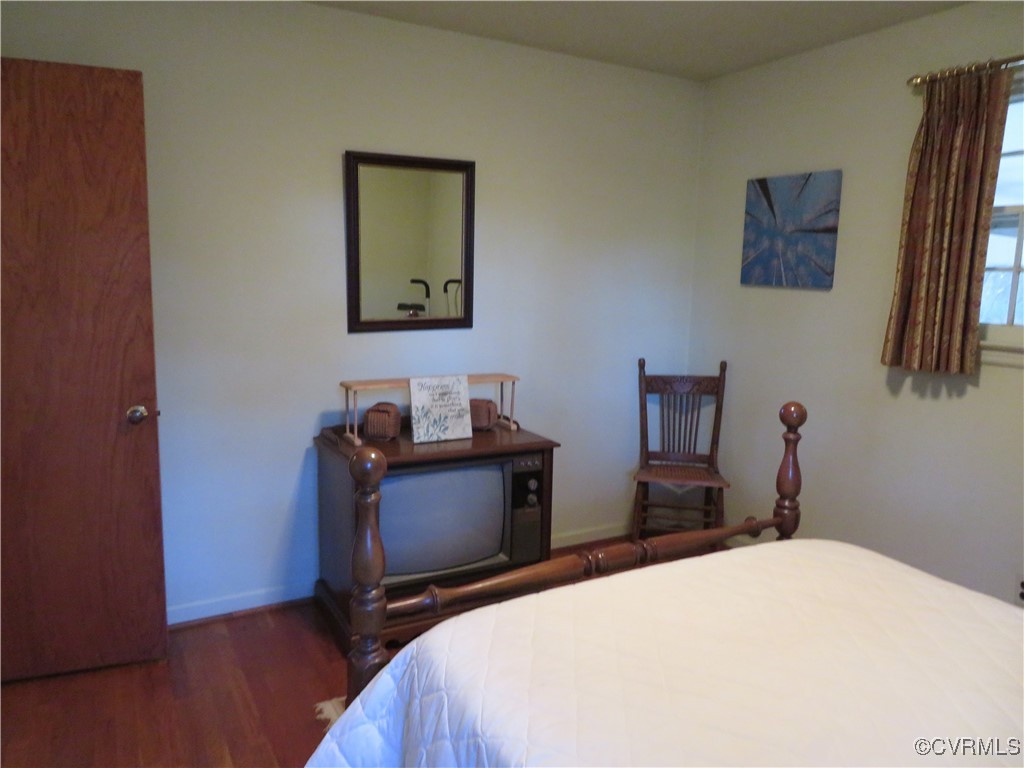 4612 Fairway Road Petersburg, VA 23803 - Photo 38 of 50 a bedroom with a bed and wooden floor