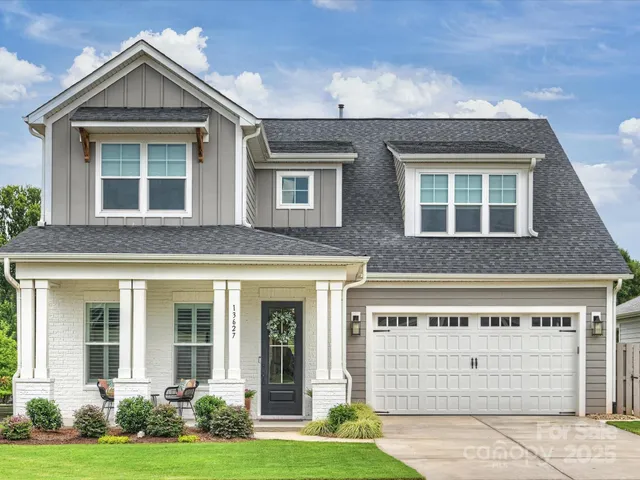 a view of a brick house with a small yard