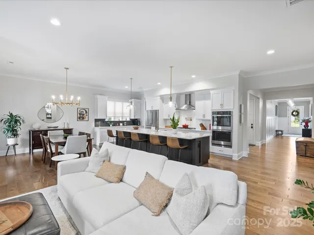 a living room with furniture kitchen and a table