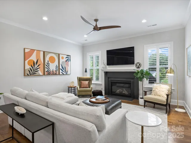 a living room with furniture a flat screen tv and a fireplace