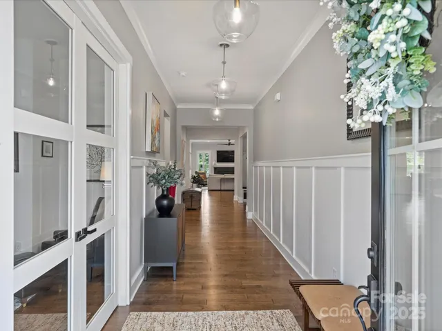 a view of a hallway with wooden floor and staircase