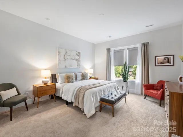 a bed room with a bed and a chair