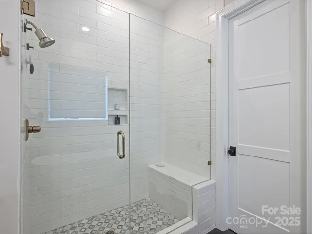 a bathroom with a shower and a sink