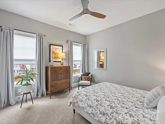 a bedroom that has a bed and a dresser in it