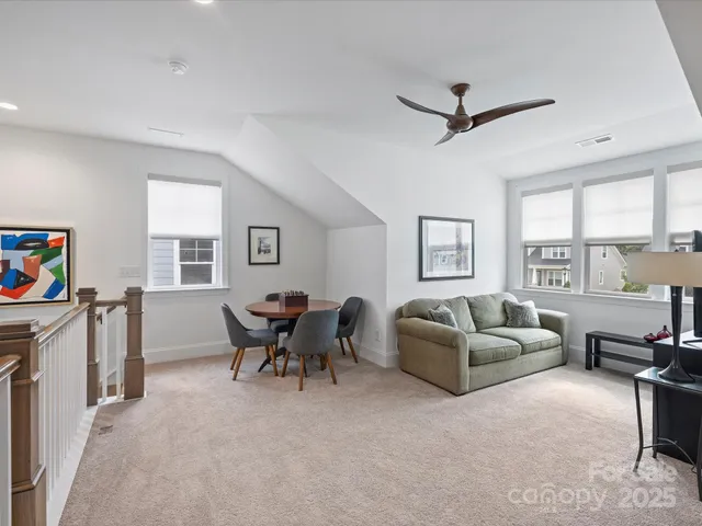 a living room with furniture a fireplace and a window