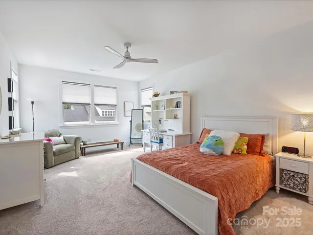 a spacious bedroom with a bed and furniture