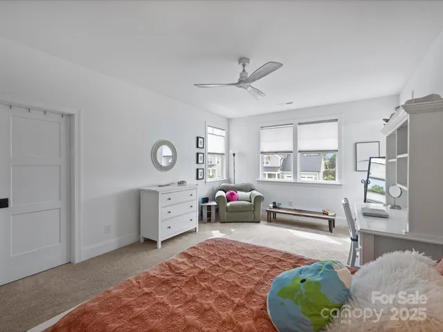 a bedroom with furniture and a window