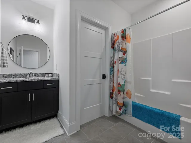 a bathroom with a mirror a sink and a mirror