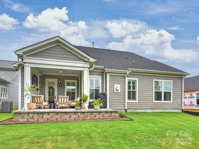 a view of a house with a yard porch and sitting area
