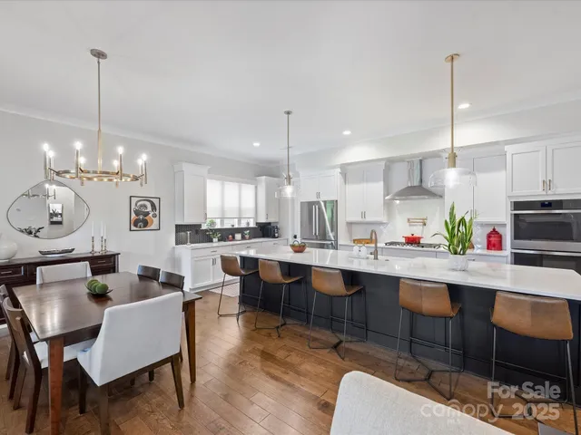 a large kitchen with a table and chairs