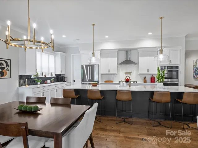 a large kitchen with a table and chairs in it