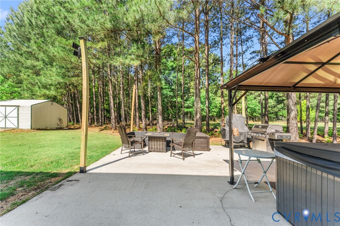 3120 Denise Road Petersburg, VA 23805 - Photo 10 of 51 Expansive concrete patio bordered by mature trees