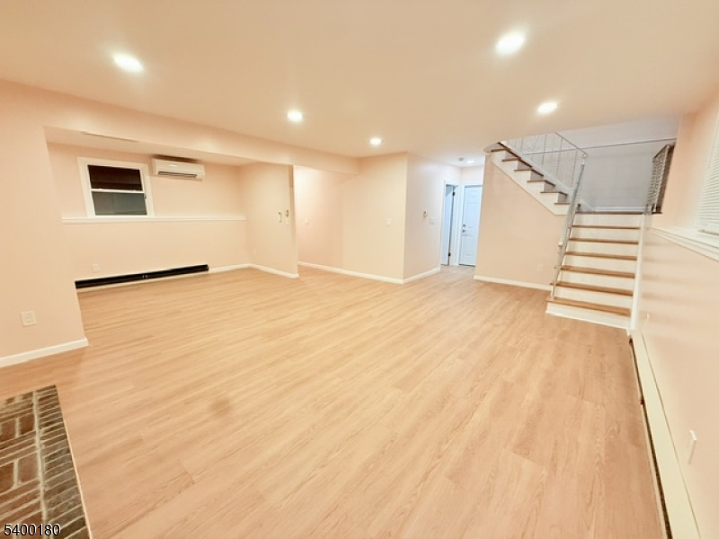 6 Hillside Avenue Netcong, NJ 07857 - Photo 17 of 28 a view of an empty room with wooden floor and a window