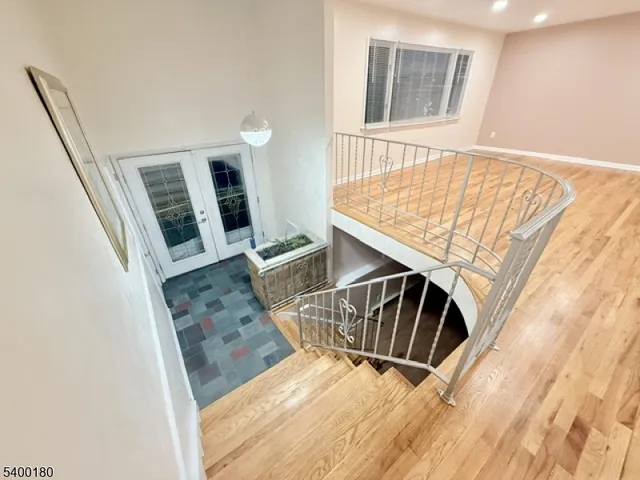 a view of entryway with furniture and wooden floor