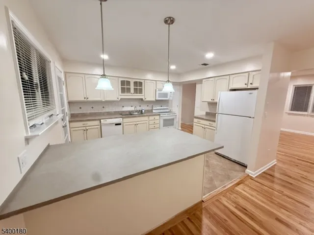 a kitchen with stainless steel appliances granite countertop a refrigerator a oven a sink and a refrigerator