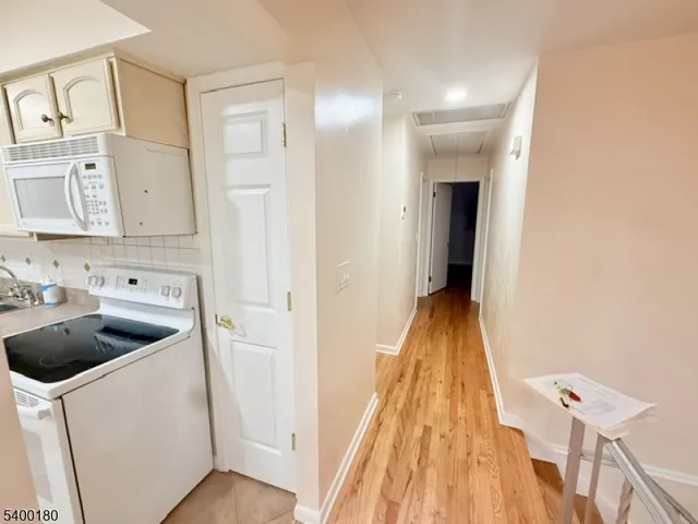 a view of washer and dryer with wooden floor