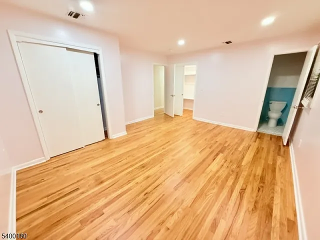 a bedroom with a bed and a mirror