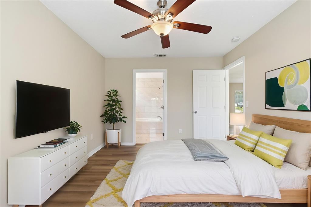 617 Greys Ferry Road Orlando, FL 32811 - Photo 7 of 35 a bedroom with a bed and a flat screen tv