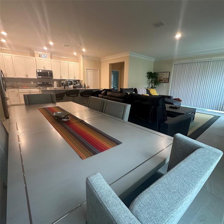 12304 Southwest Forli Way Port St. Lucie, FL 34987 - Photo 12 of 26 a living room with furniture and a view of kitchen