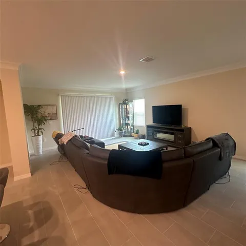 a spacious bedroom with a bed and a couch