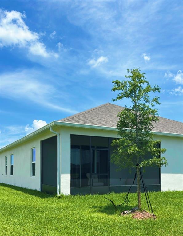 12304 Southwest Forli Way Port St. Lucie, FL 34987 - Photo 16 of 26 a view of a house with a yard