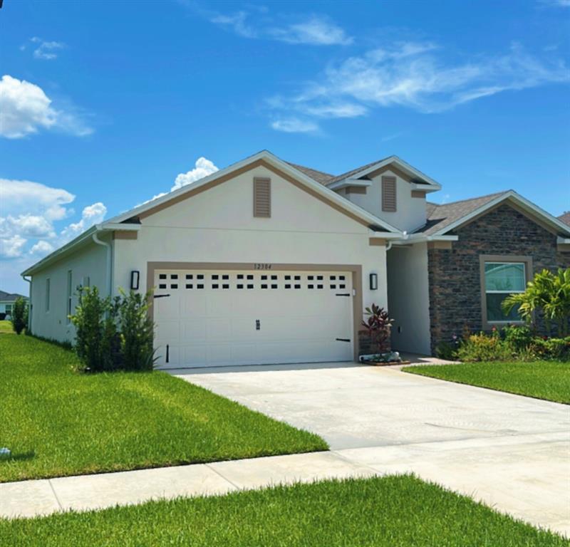 12304 Southwest Forli Way Port St. Lucie, FL 34987 - Photo 2 of 26 a front view of a house with a garden