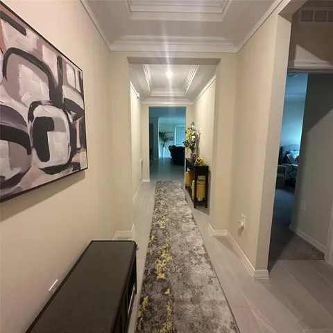 a view of hallway with livingroom and stairs