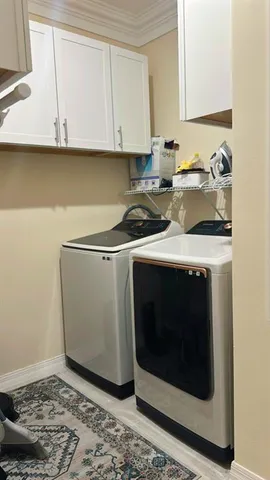 a kitchen with a stove and white cabinets