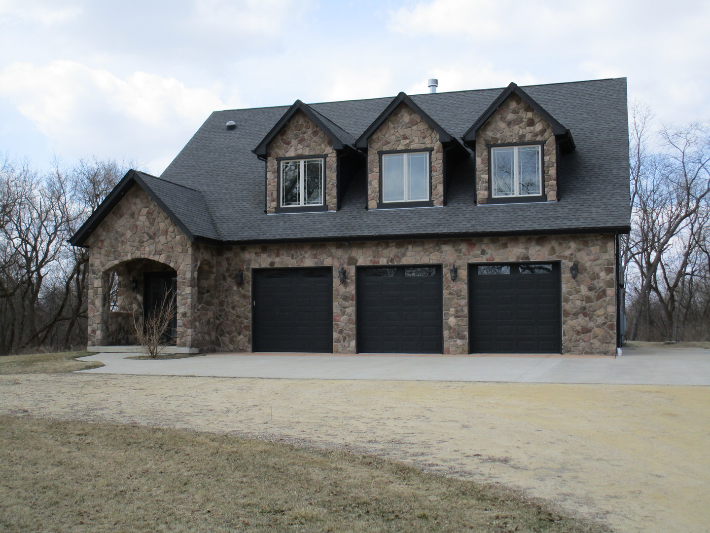 6909 Schultz Road Harvard, IL 60033 - Photo 2 of 19 a front view of a house with large trees