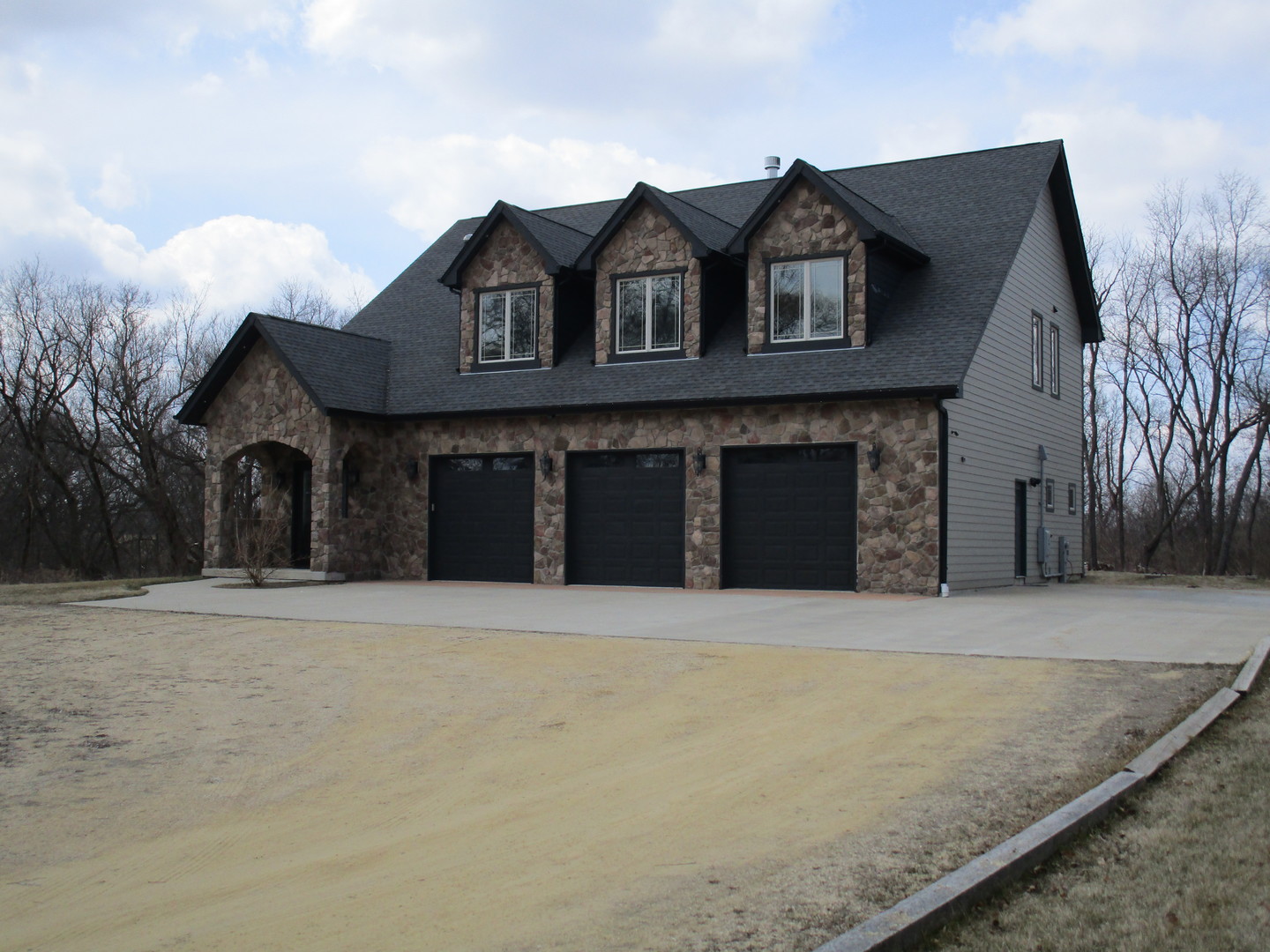 6909 Schultz Road Harvard, IL 60033 - Photo 3 of 19 a front view of a house with a yard and garage