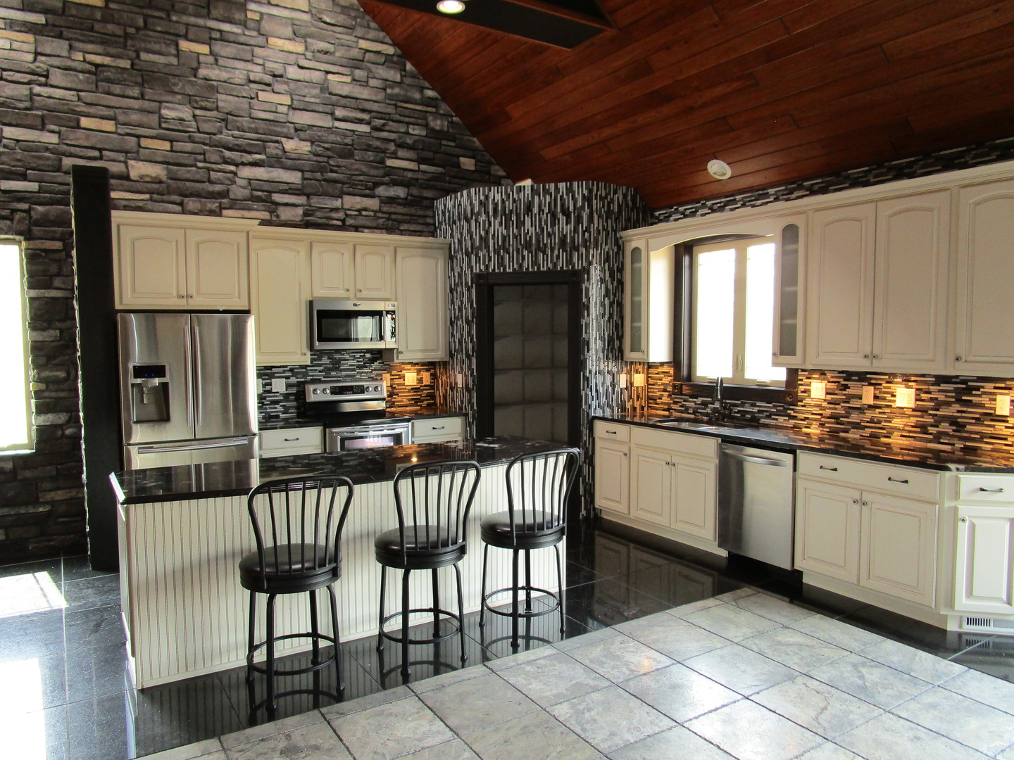 6909 Schultz Road Harvard, IL 60033 - Photo 10 of 19 a kitchen with granite countertop a stove a sink and a refrigerator
