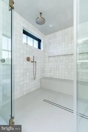 a bed room with a bed mirror and a window