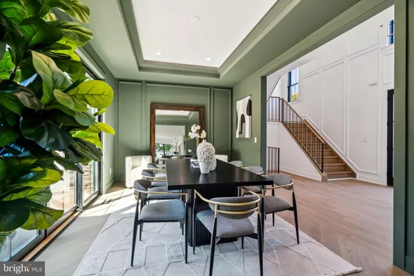 a dining room with furniture and wooden floor