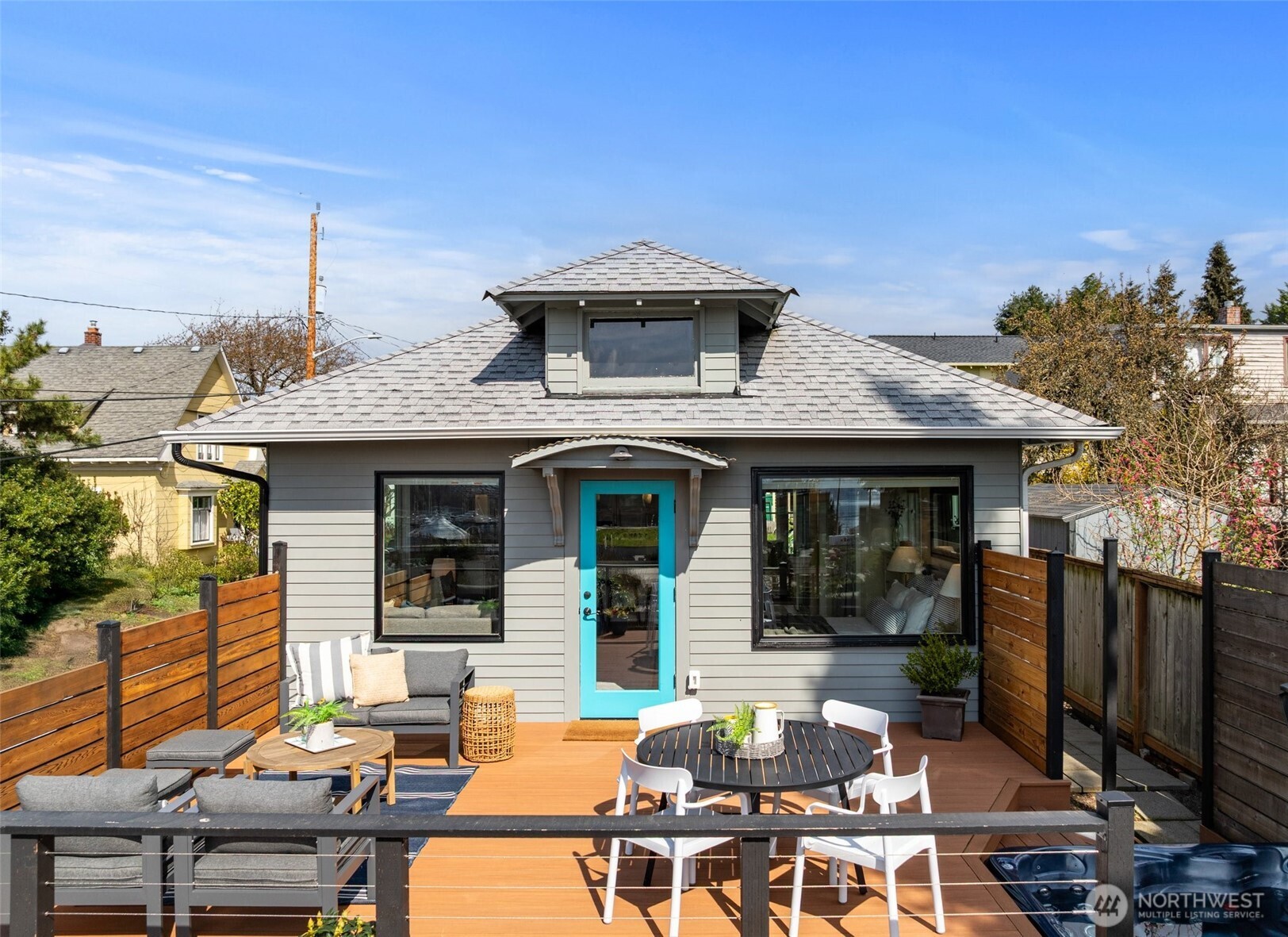 a view of a patio with table and chairs a barbeque with wooden floor and fence