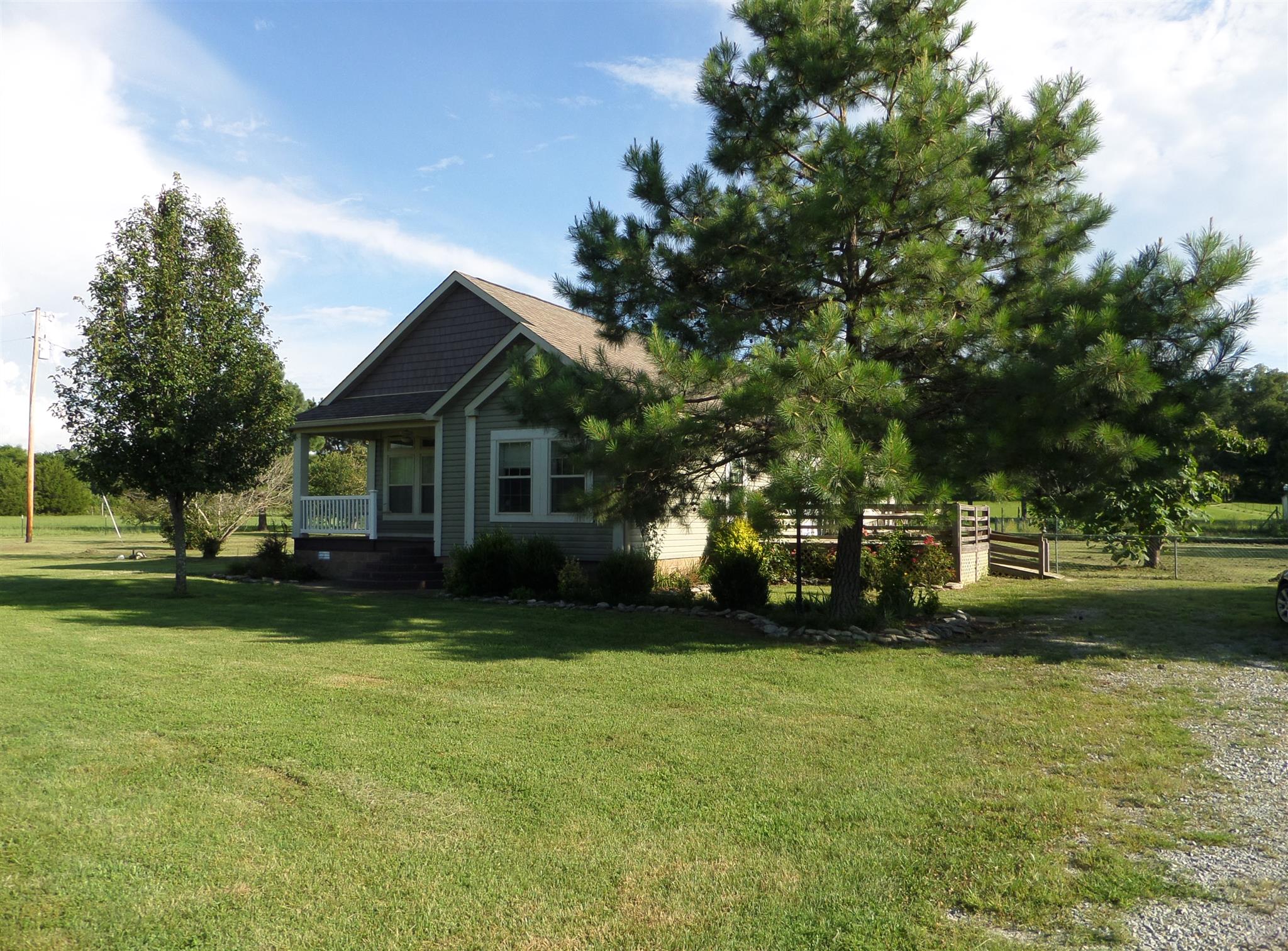 855 Cut Off Road Pulaski, TN 38478 - Photo 1 of 26 a front view of a house with a garden
