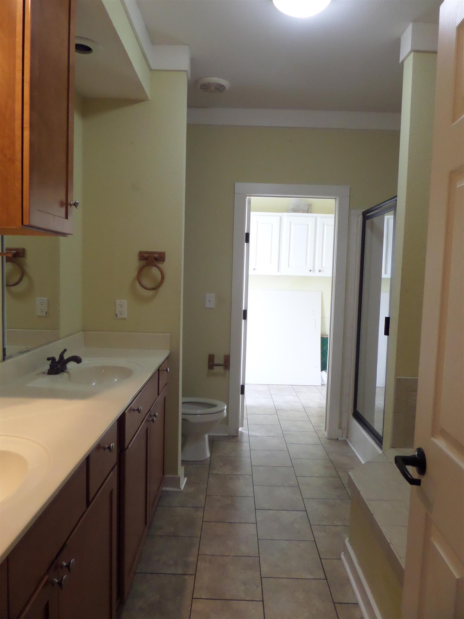855 Cut Off Road Pulaski, TN 38478 - Photo 13 of 26 a bathroom with a sink a toilet and a mirror