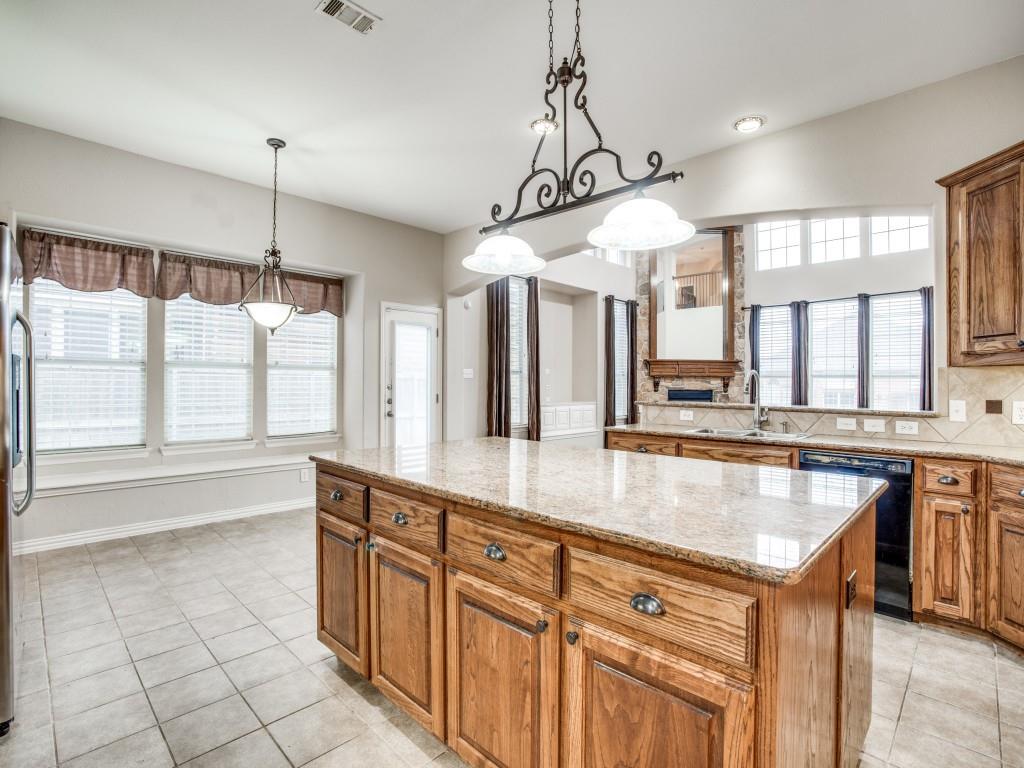 2613 Sandstone Lane Midlothian, TX 76065 - Photo 13 of 36 a large kitchen with kitchen island a large counter space a sink appliances and cabinets