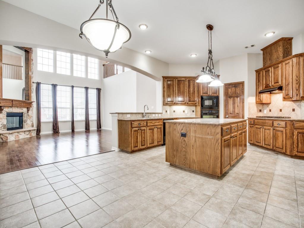 2613 Sandstone Lane Midlothian, TX 76065 - Photo 14 of 36 a large kitchen with stainless steel appliances kitchen island granite countertop a large counter top a sink a stove and a window