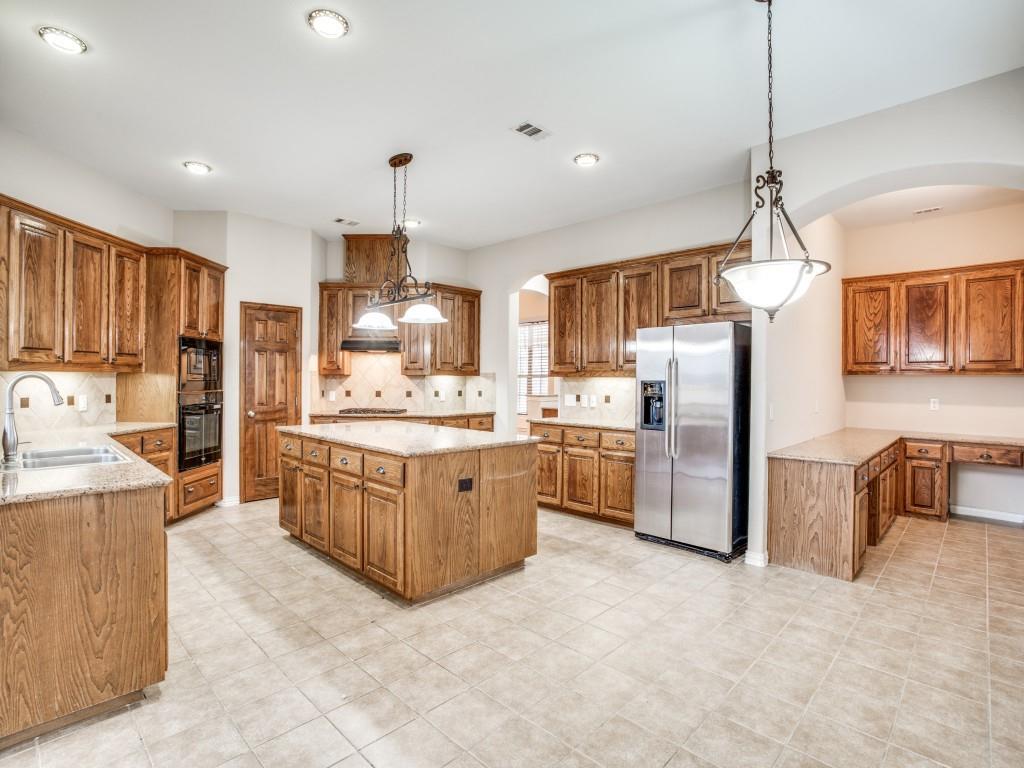 2613 Sandstone Lane Midlothian, TX 76065 - Photo 15 of 36 a kitchen with granite countertop a refrigerator oven a sink dishwasher and wooden cabinets with wooden floor