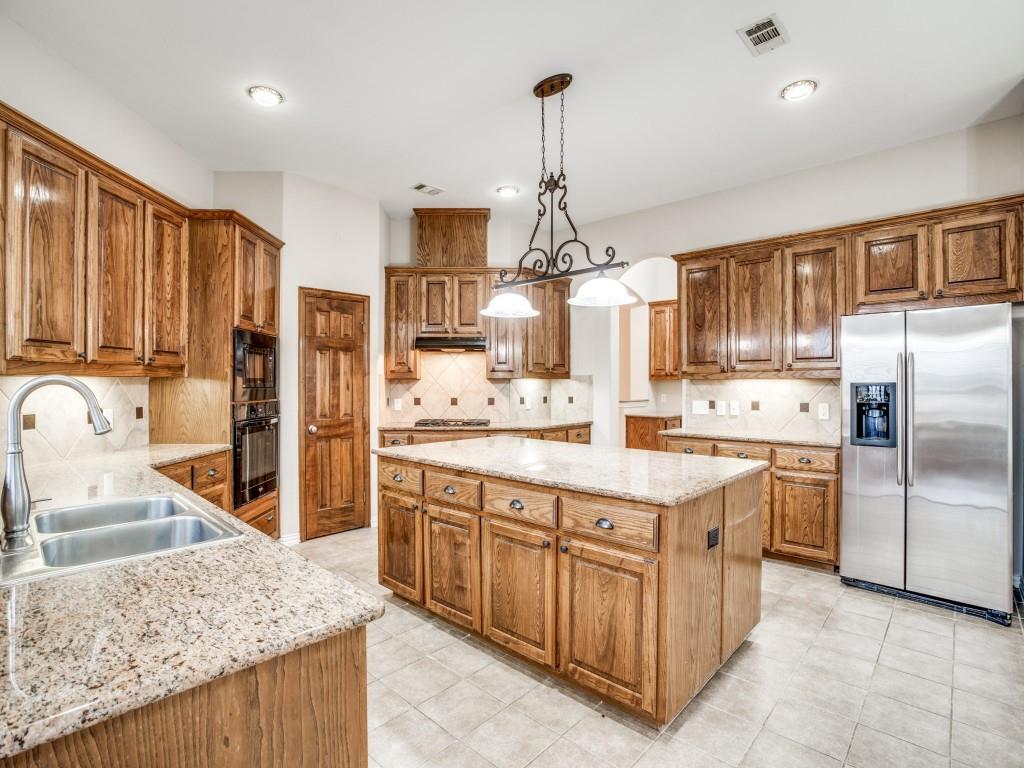 2613 Sandstone Lane Midlothian, TX 76065 - Photo 16 of 36 a kitchen with stainless steel appliances granite countertop a sink stove and refrigerator
