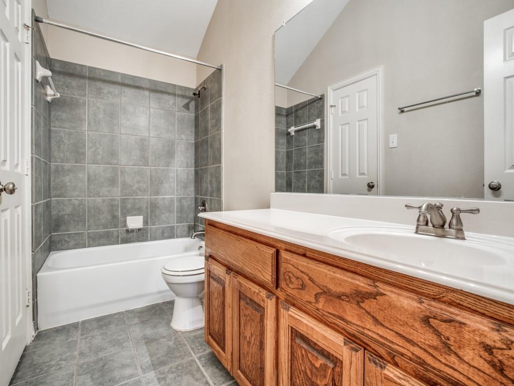 2613 Sandstone Lane Midlothian, TX 76065 - Photo 32 of 36 a bathroom with a bathtub shower sink vanity and toilet