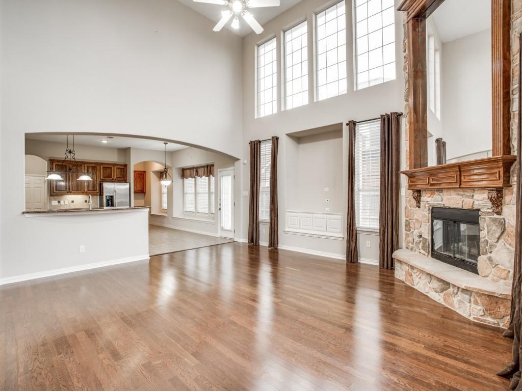 2613 Sandstone Lane Midlothian, TX 76065 - Photo 10 of 36 a view of an empty room with wooden floor and a fireplace