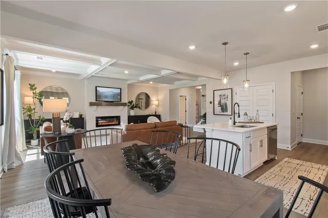 a living room with furniture kitchen and a table