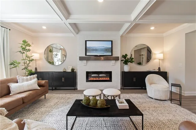 a living room with furniture and view of kitchen