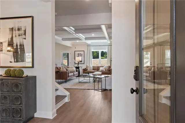 a living room with lots of furniture and kitchen view