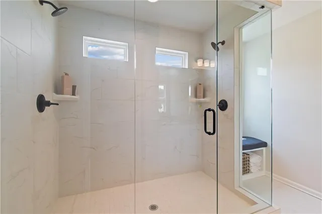 a bathroom with a sink a toilet a mirror a vanity and shower